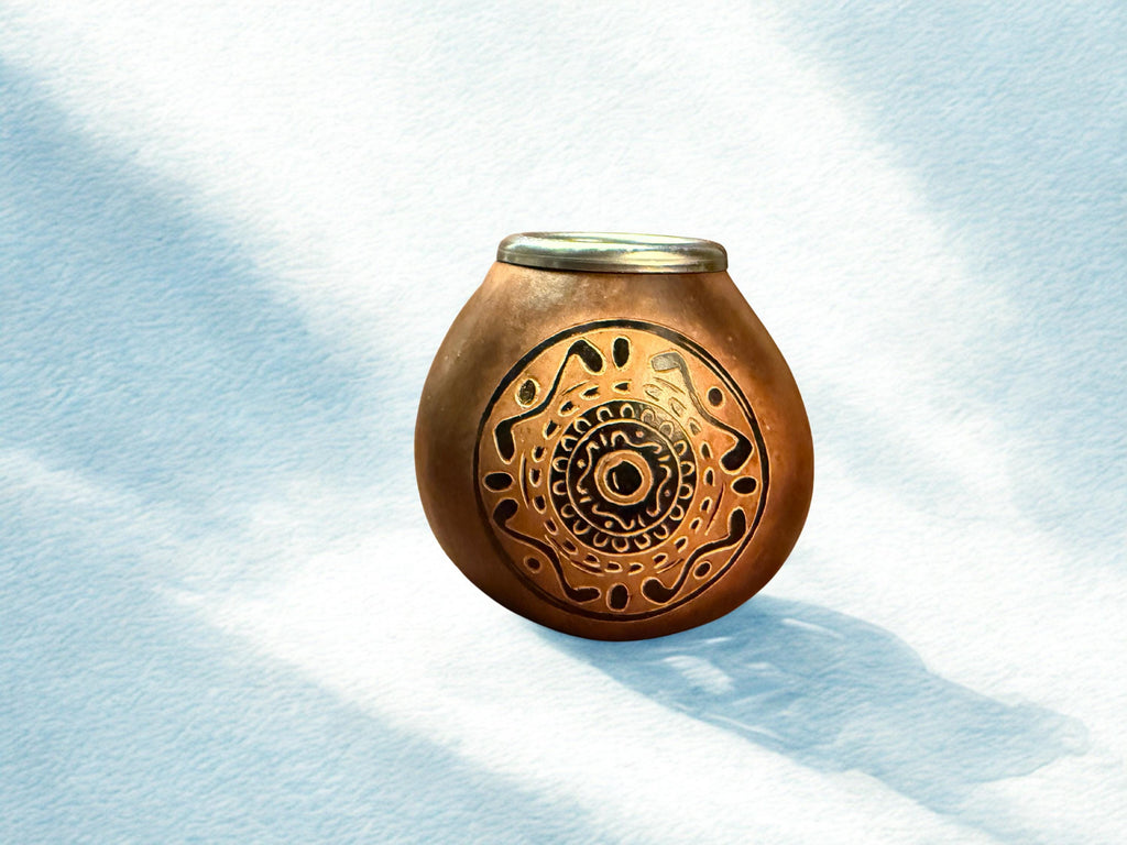 A small rounded brown ceramic pot with a metallic lid and an intricate circular cutout pattern on the front, set against a textured light blue background with soft shadows.